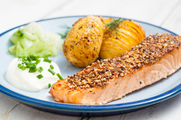Scandinavian salmon with potatoes and pickled cucumber.