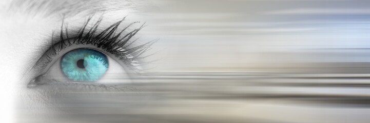 Close up of eye with bright blue iris and blurry grey transition
