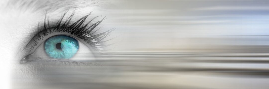 Close up of eye with bright blue iris and blurry grey transition
