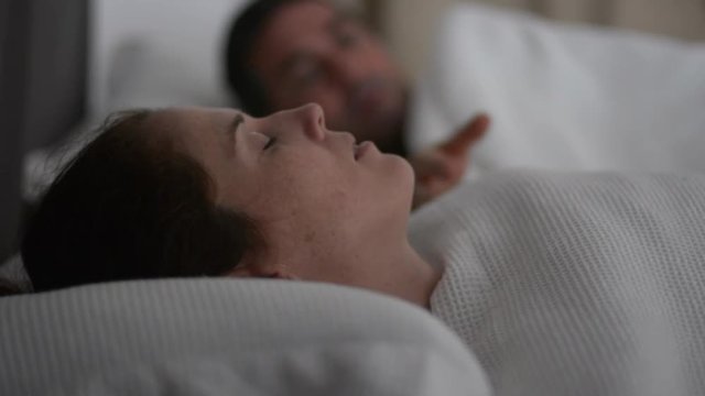 Man suffers from his woman snoring in bed