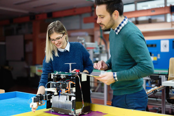 Fototapeta premium Young students of robotics preparing robot for testing