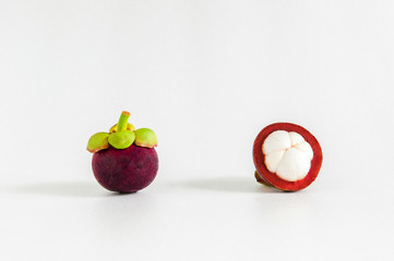 Isolated whole and cut open Mangosteens