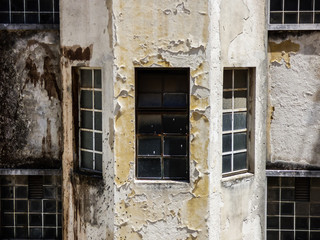 Windows of an old decaying apartment building in Lisbon