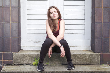 portrait of a smiling young woman sitting on a step