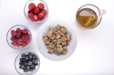 Healthy granola cereal  with portions of raspberries blueberries and strawberries 