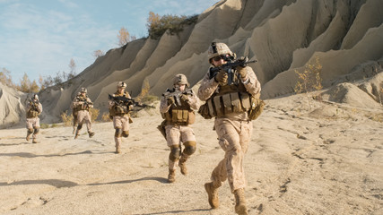 Squad of Fully Equipped, Armed Soldiers Running in the Desert. Show Motion.