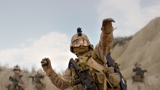 Soldier Throwing A Grenade During Combat In The Desert.