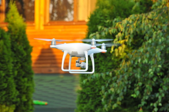 White drone quadrocopter with camera 
