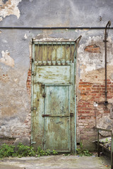 grunge metal door, cracked brick wall background