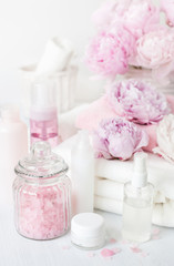 Fototapeta na wymiar bath and spa with peony flowers beauty products towels