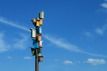 A lot of birdhouses at sky background