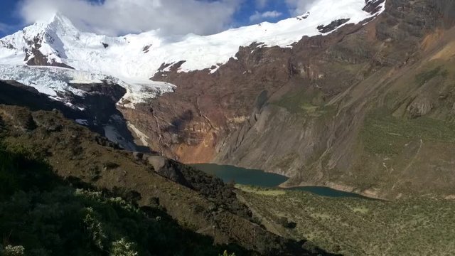 Emerald blue lake Peru mountains, time lapse of clouds