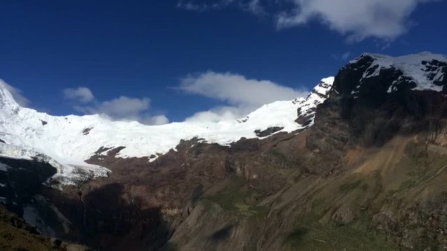 Emerald blue lake Peru mountains, time lapse of clouds