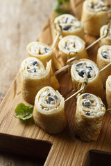 Pancakes appetizer with cream cheese and olives