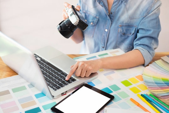 Photography Ideas Creative Occupation Design Studio Concept, Female photographer sitting on the desk with laptop