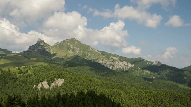 4 k timelapse of fast moving cloud shadows, white clouds and blue sky in Ciucas Mountains, Romania.