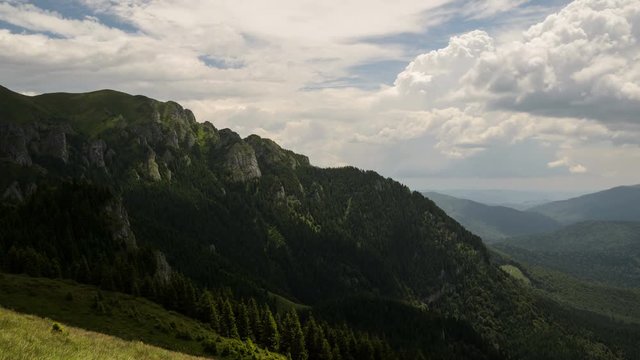 4 k timelapse of fast moving cloud shadows, white clouds and blue sky over a hill slope in Ciucas Mountains, Romania.