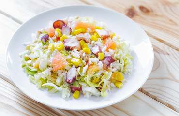 Summer salad with rice, coctopus, corn and vegetables. Concept of healthy food.