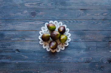 Fresh figs with peaches, apricots, blueberries, strawberries, on a wooden  background.