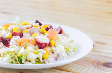 Cold summer salad with rice, coctopus, corn and vegetables. Concept of healthy food.