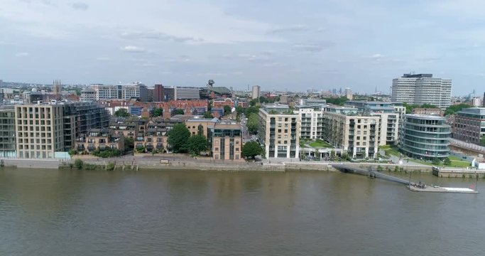 Aerial panning view of luxury housing develpments by the river Thames in Hammersmith, West London