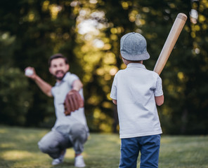 Dad with son playing baseball