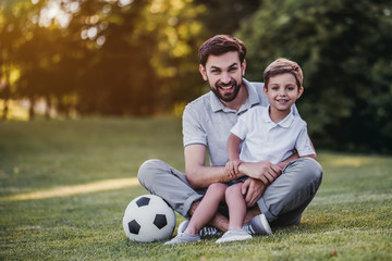 Dad with son playing football