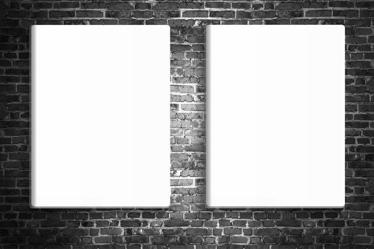 Two blank posters hanging on the brick black wall of broken painted brick, mock up