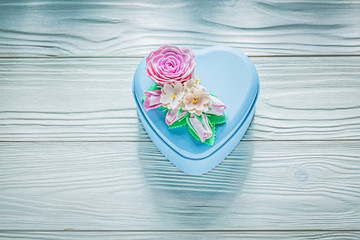 Heart-shaped present box on wooden board holidays concept