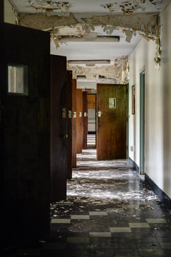 Derelict Hallway with Open Doors and Peeling Paint - Abandoned Hospital