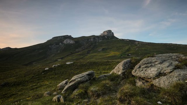Sunset over Bucegi Plateau, Carpathians Mountains. Bucegi plateau is at high elevation where wind and rain have turned the rocks into spectacular figures such as Sphinx and Babele.  4k timelapse. 