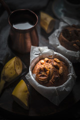 Aromatic coffee with banana cupcake on the wooden table