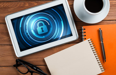 Web security and technology concept with tablet pc on wooden table