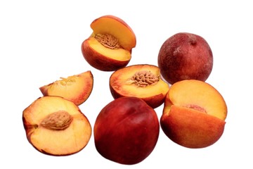 Peaches whole and sliced halves with a bone isolated on white background