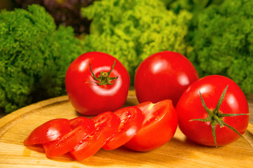 Fresh tomatoes on a wooden background. Delicious vegetarian food