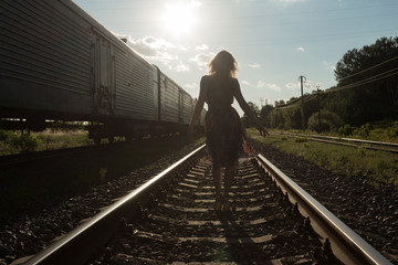 Desperate girl to walk on the railroad