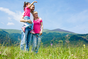 family with kids travel hiking in mountains