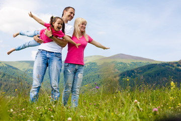 Fototapeta premium Attractive family having fun in a summer on mountain