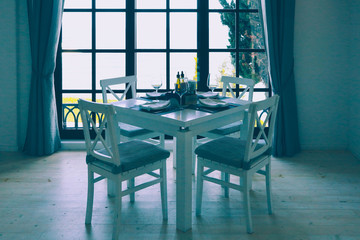 Beach restaurant interior. Greek cafe on the seaside, white wooden furniture, sunny.