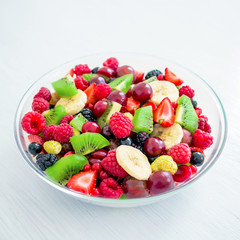 Fresh fruit salad in glass plate on white  background