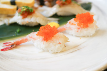 shrimp sushi with orange fly fish eggs on top