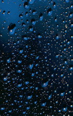 Water and rain drops on the glass, abstract view, Drops of rain on blue glass background / drops on glass after rain