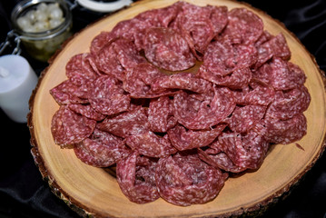 Spanish serrano ham on wooden board in night event party