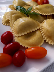 Italian pasta, ravioli, with basil and tomatoes