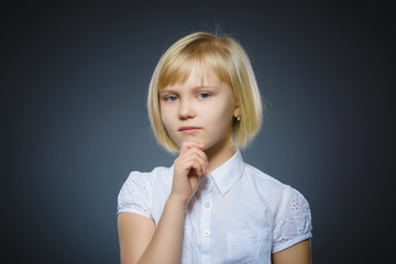 Closeup Thoughtful girl with Hand at head isolated on Gray