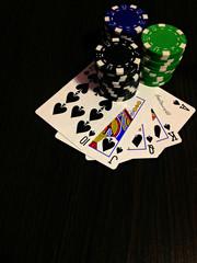 Black colours of poker game concept.  Plot with bones, chips and cards