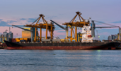 container ship in import export and business logistic.By crane , Trade Port , Shipping.Tugboat assisting cargo to harbor.Aerial view. Top view.