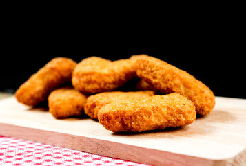 Delicious fried Chicken nuggets on table