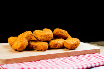 Delicious fried Chicken nuggets on table