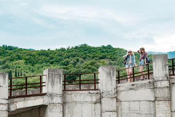 Fototapeta na wymiar Beautiful mountain landscape, concrete bridge, two girls